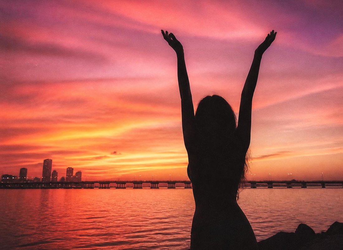Silhouette against a pink sky over the Venetian Causeway